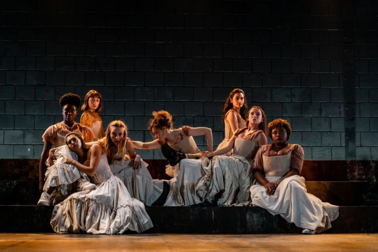 Group of actors on stage in period costume